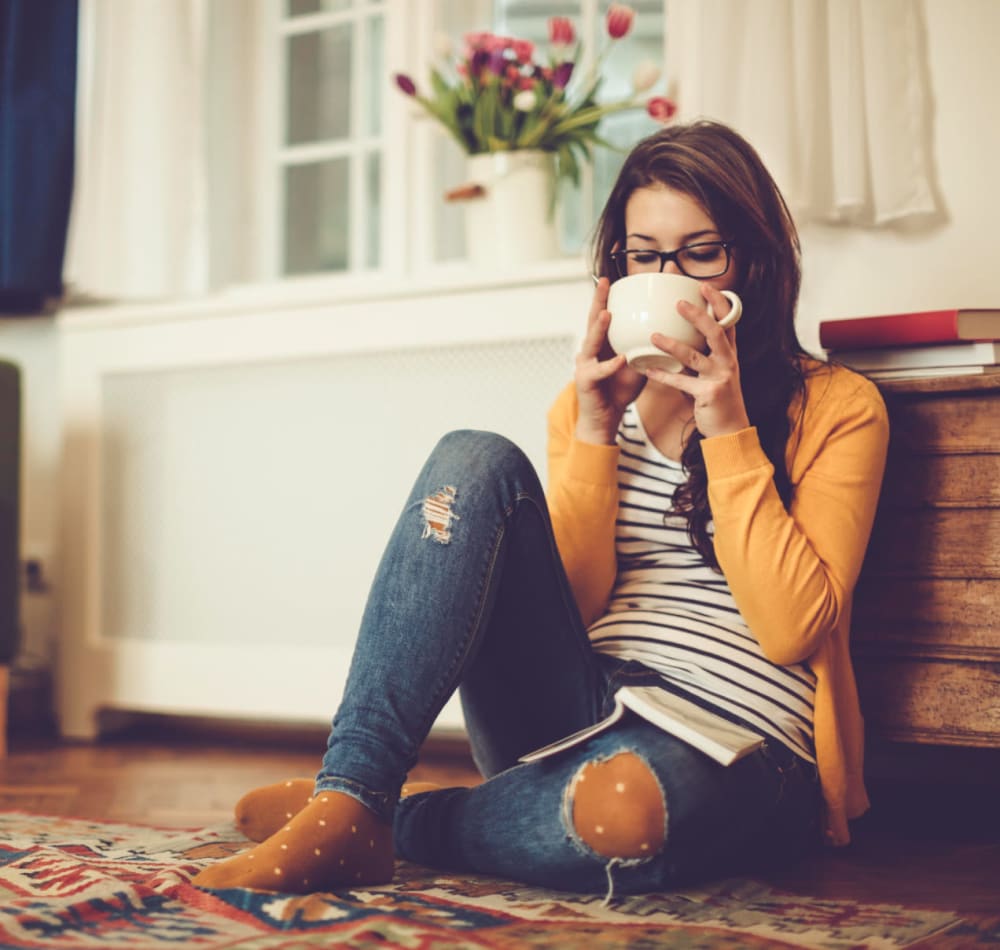 Resident enjoying a cup of tea in her apartment at Terra at Portola Park in Livermore, California