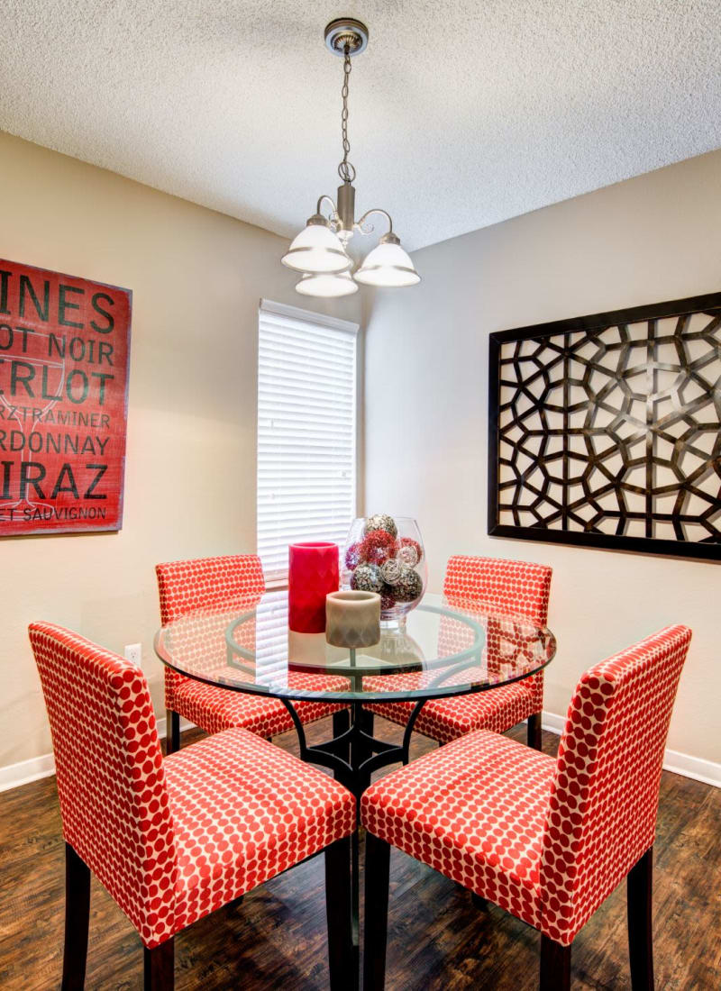 Bright dining area with a glass table at The Park at Flower Mound in Flower Mound, Texas