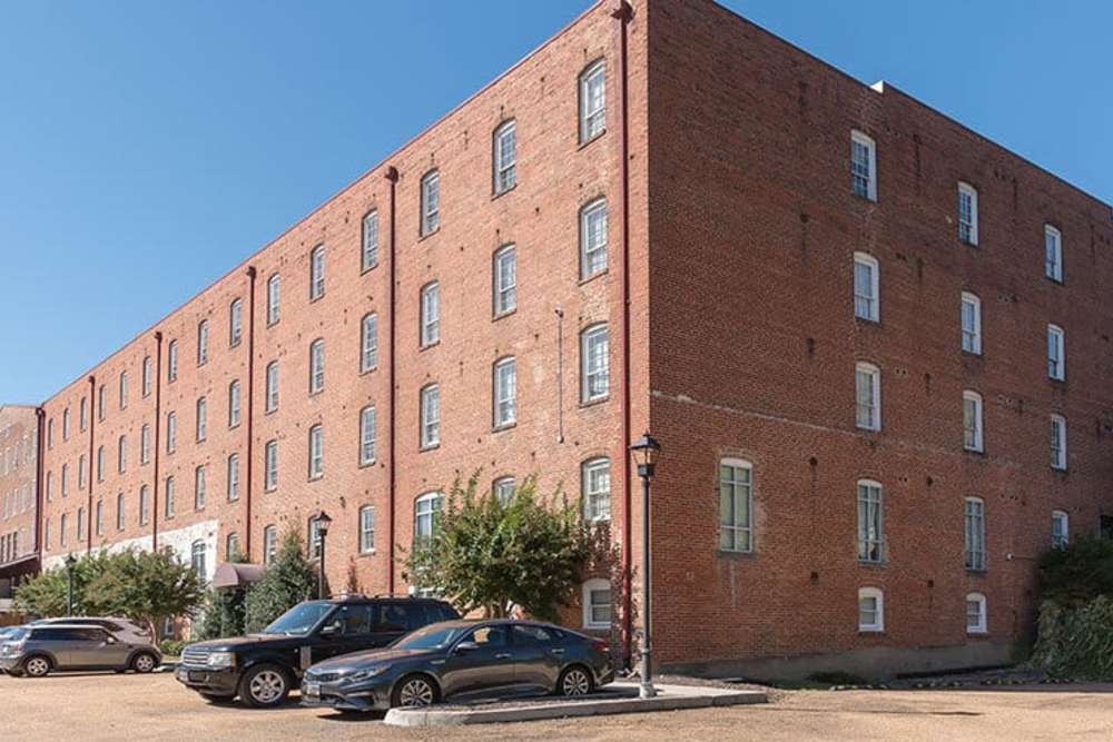 Exterior shot of an apartment with parking area at High Street Lofts in Petersburg, Virginia