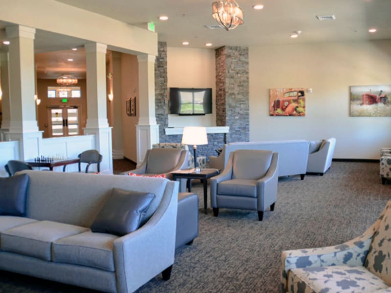 Lounge room with several spots to sit and large open windows at Aspen Valley Senior Living in Boise, Idaho