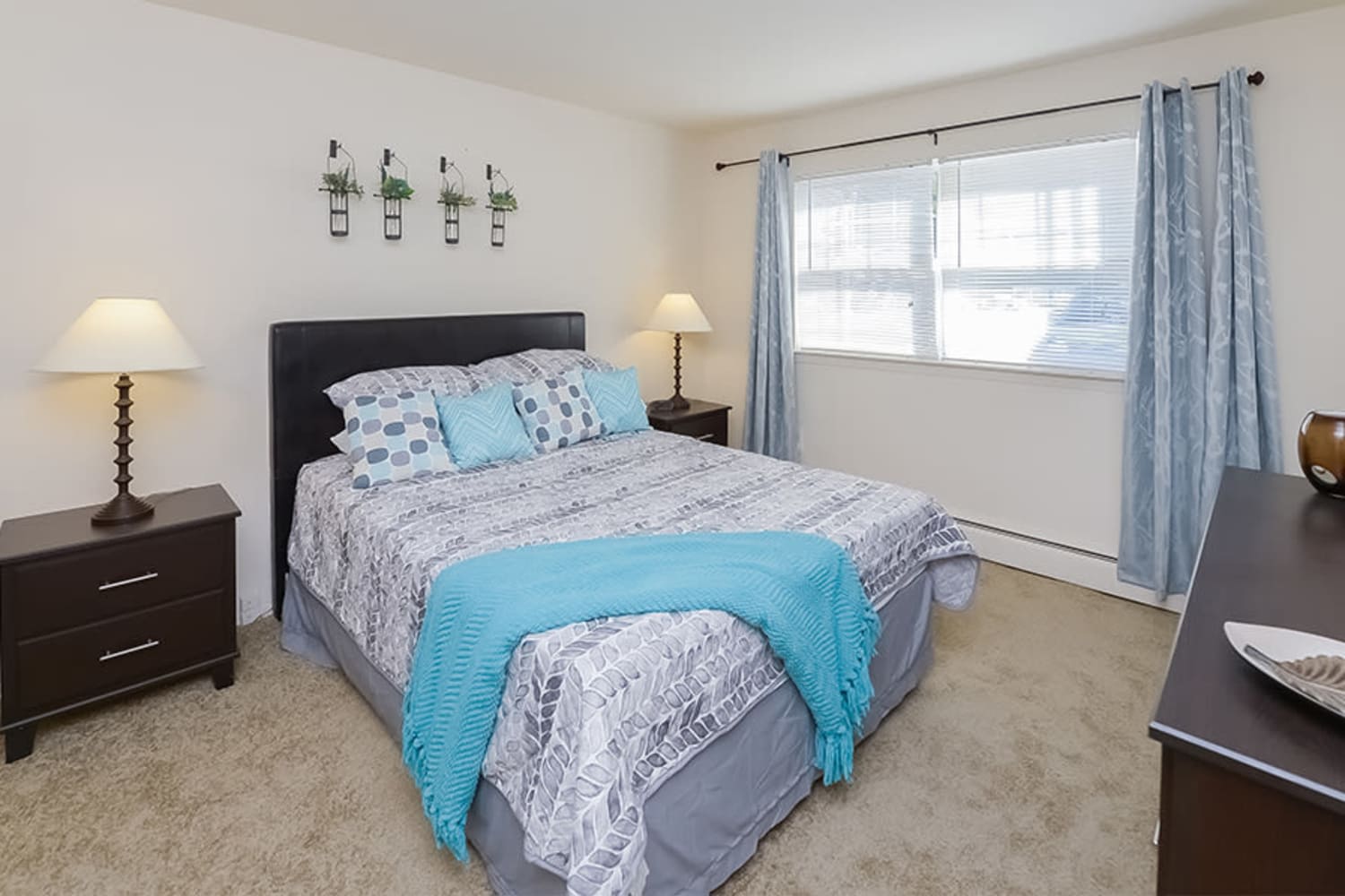 Model bedroom with plush carpeting at Nieuw Amsterdam Apartment Homes in Marlton, New Jersey