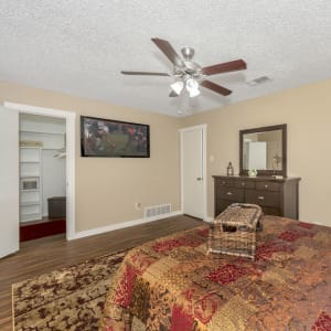 Model bedroom with walk-in closet and ceiling fan at Buffalo Ranch in Farmersville, Texas