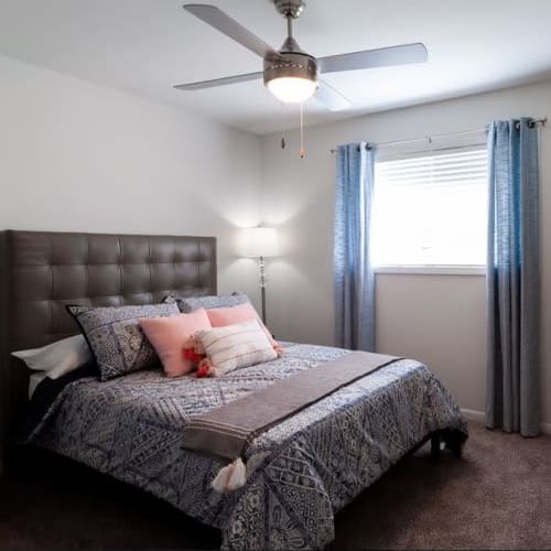 Ceiling fan and bright window in a cozy bedroom at Amber Grove Apartments in Marietta, Georgia