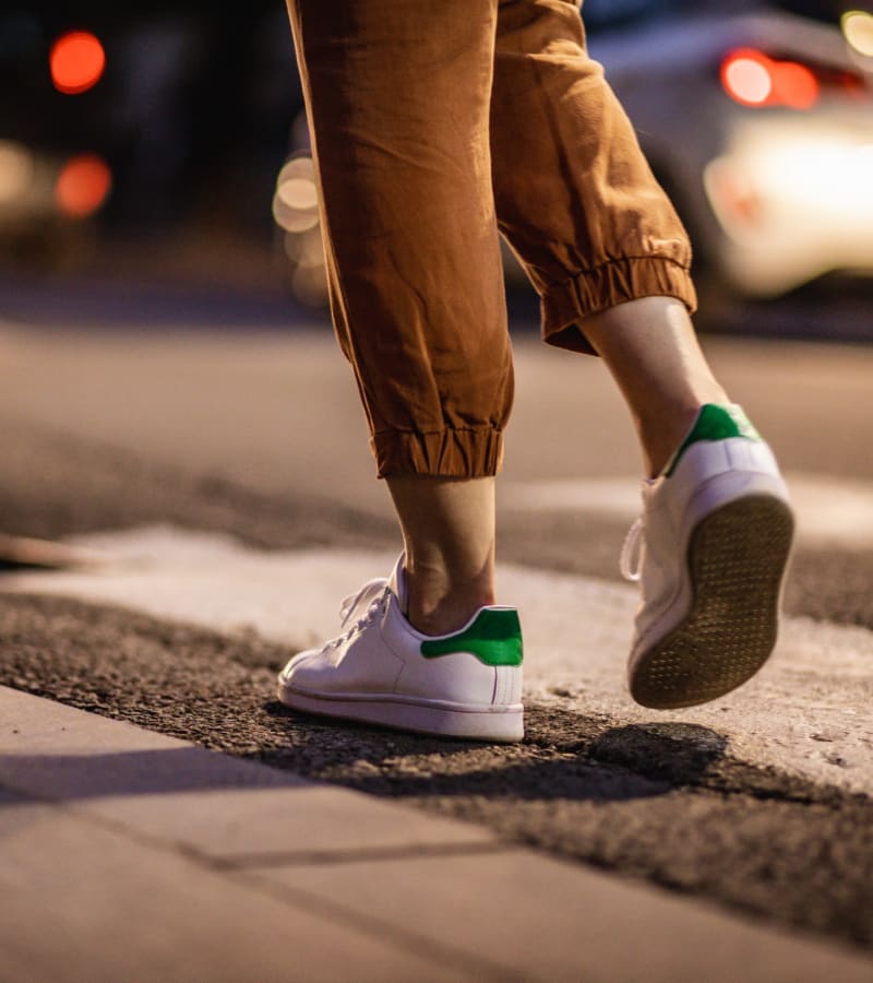 Resident crossing a street in town in James River Pointe in Richmond, Virginia