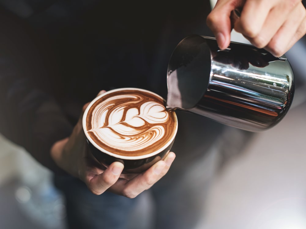 Barista making a latté for a customer near Sofi at Forest Heights in Portland, Oregon