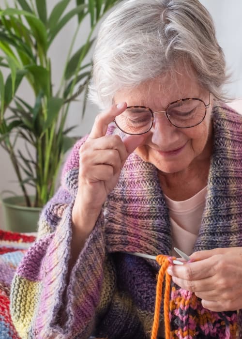 Resident knitting at Grand Villa of Sarasota in Sarasota, Florida