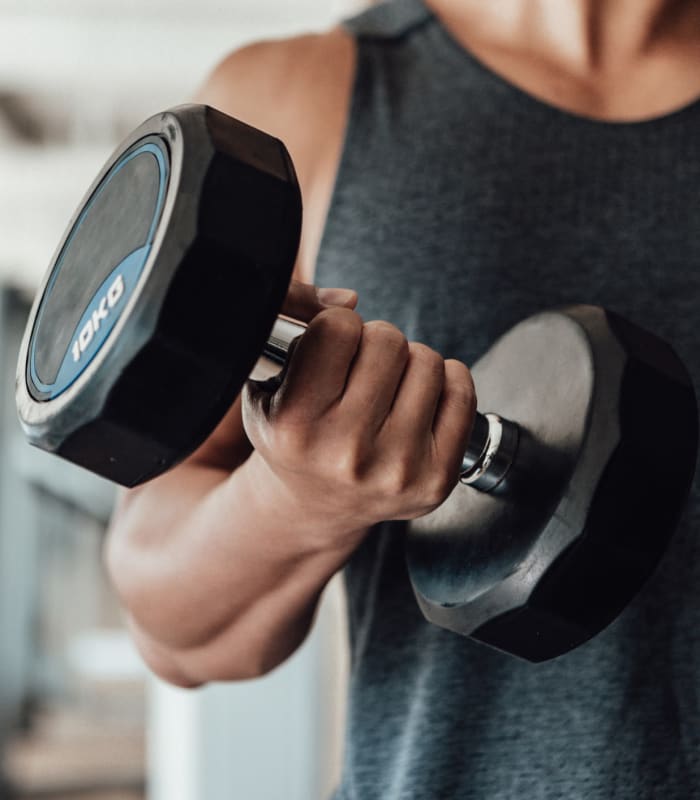 Resident lifting weights at Redbud Ranch Apartments in Broken Arrow, Oklahoma