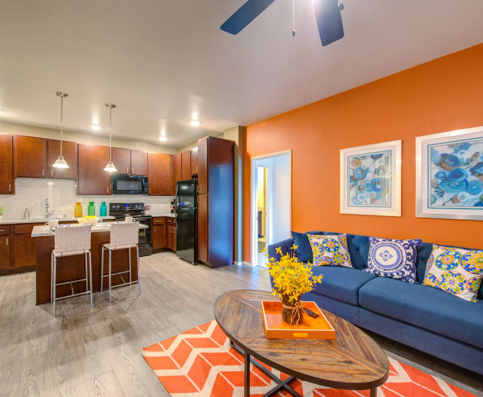 Living room with hardwood floors and ceiling fan at Kapolei Lofts in Kapolei, Hawaii