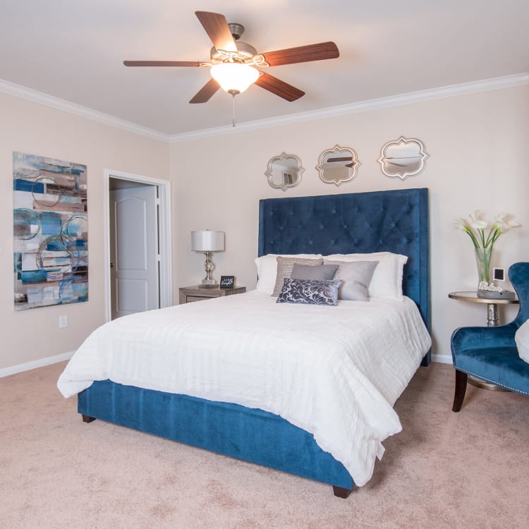 Model bedroom with a ceiling fan at Chateau de Ville
