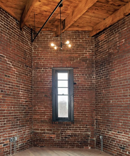 Brick walls with windows at Allegheny Branch House Lofts in Pittsburgh, Pennsylvania