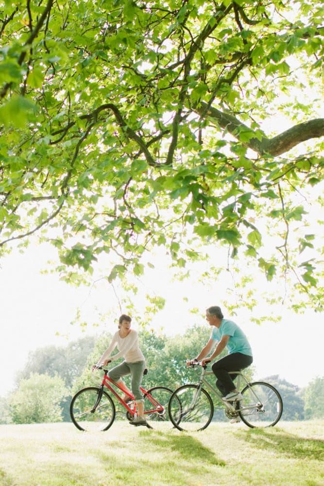 Residents riding their bikes thru a park near Campbell Flats Apartments in Springfield, Missouri