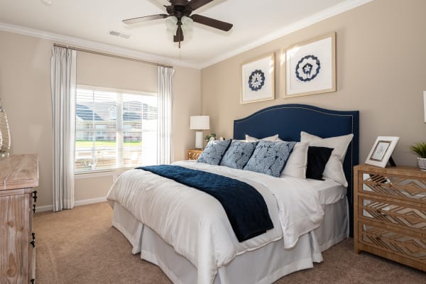 Spacious carpeted bedroom with large window at Randall Residence of West Milton in West Milton, Ohio