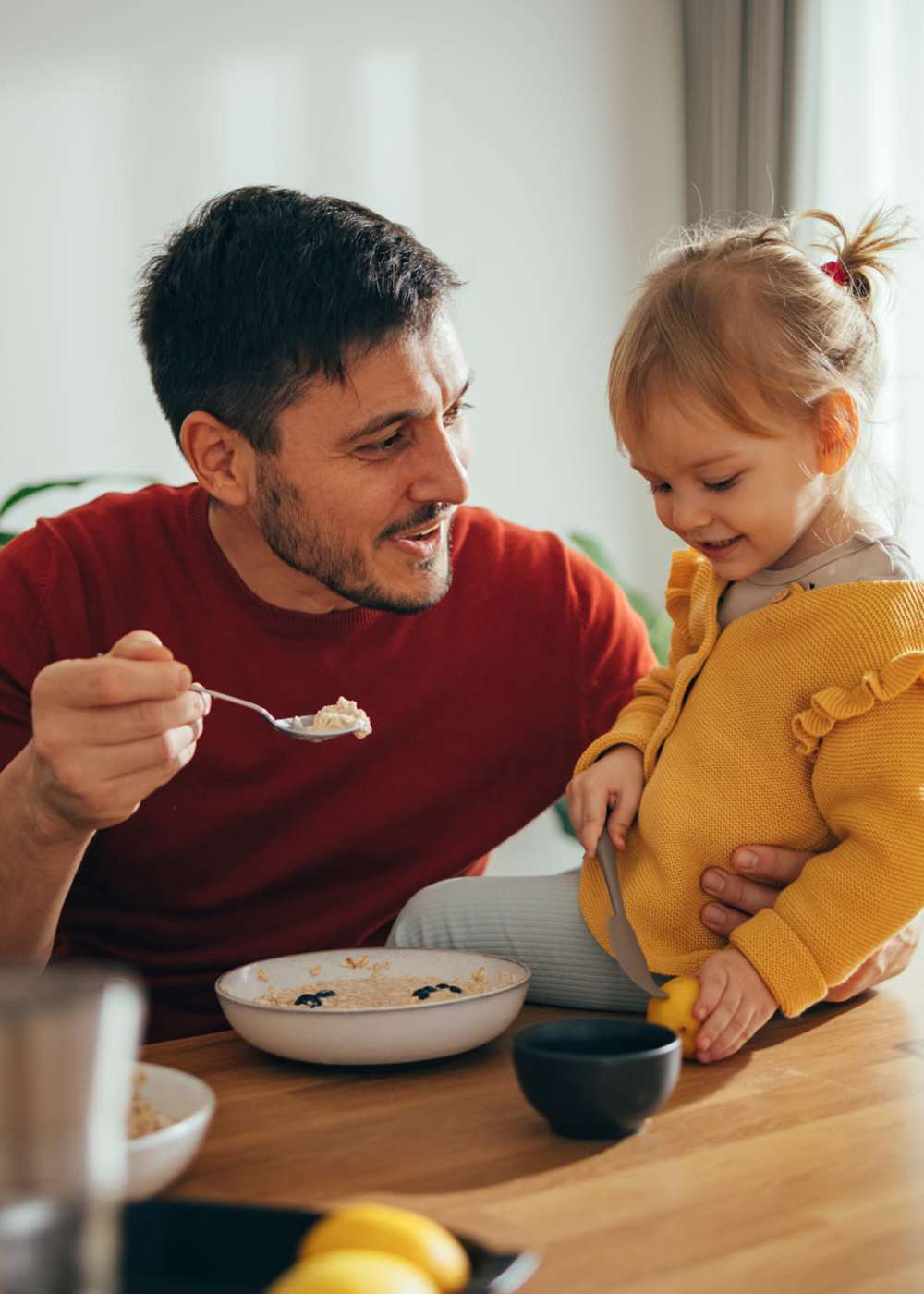 Resident feeding his daughter in the apartment at Ridge Commons in Lafayette, Louisiana