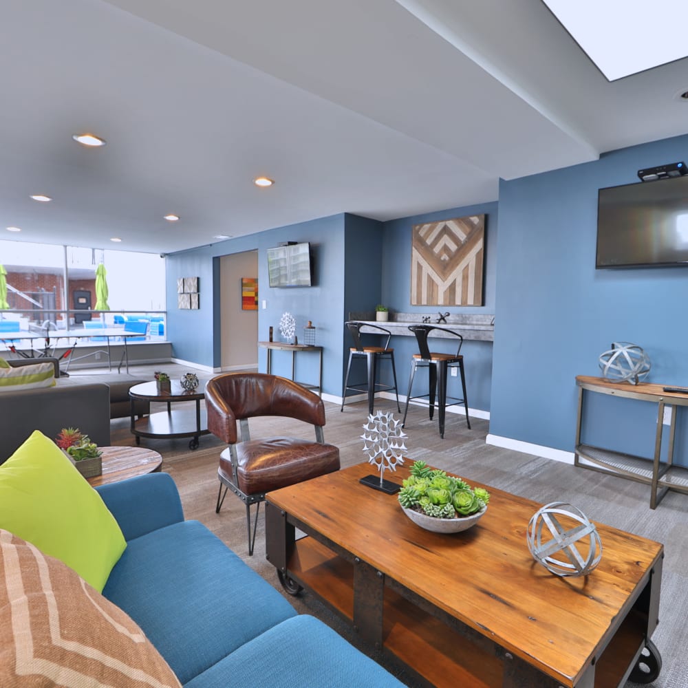 Sunroom with indoor furnishings at The Carlyle Apartments in Baltimore, Maryland