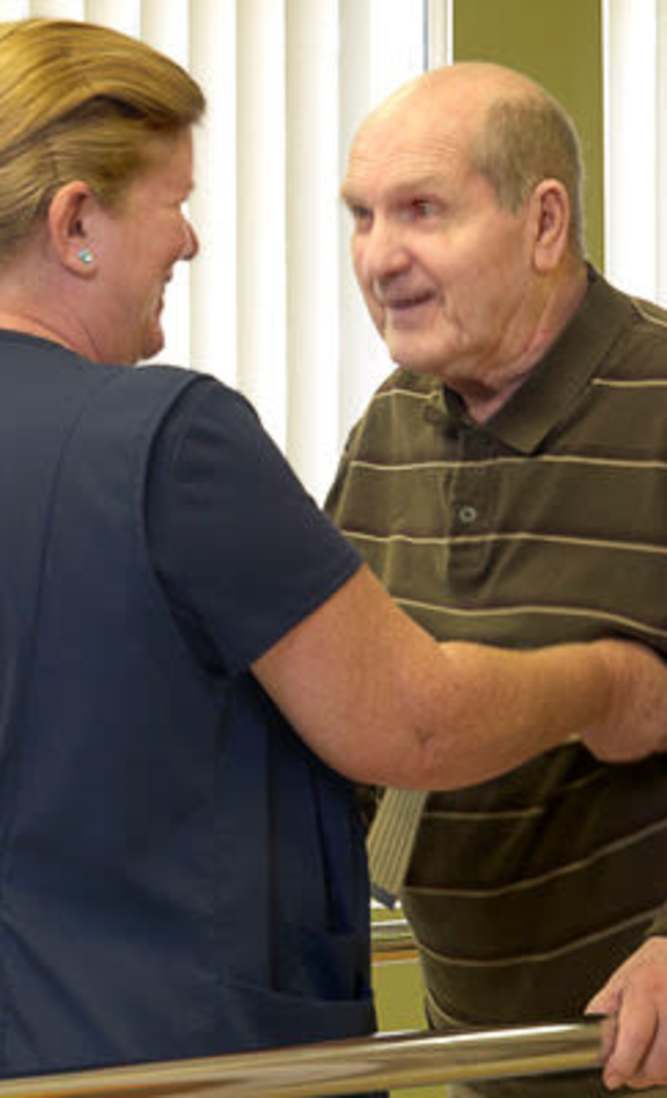 Staff helping client with his daily rehabilitation at Garden View Care Center in St. Louis, MO