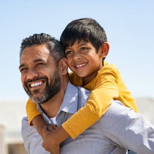 Happy resident father and son outside their new home at Hampton Village in DeSoto, Texas