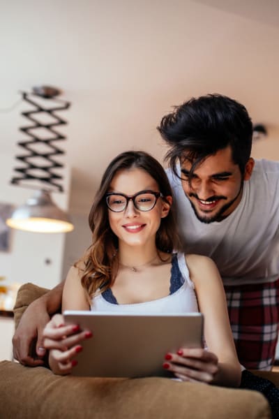 Couple looking at photos on a tablet in their new home at Steelyard in Oklahoma City, Oklahoma
