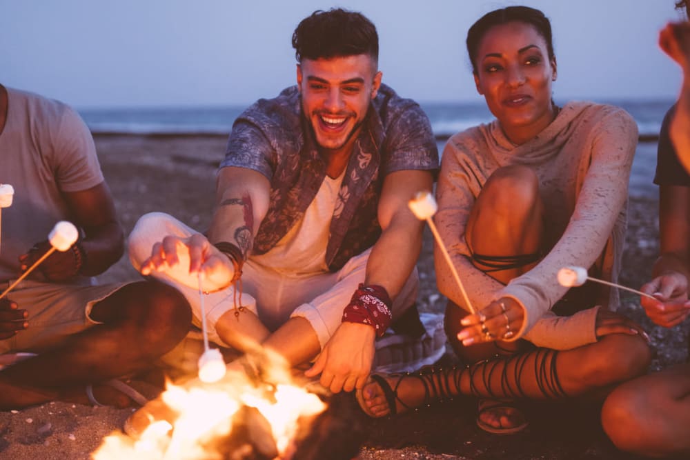 Friends having a beach campfire near BestBox Storage - Palafox in Pensacola, Florida