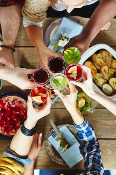 Friends enjoying food and drinks near The Towne at Northgate Apartments in Colorado Springs, Colorado