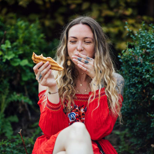 Resident enjoying a slice of pizza at Solaire 7077 Woodmont in Bethesda, Maryland