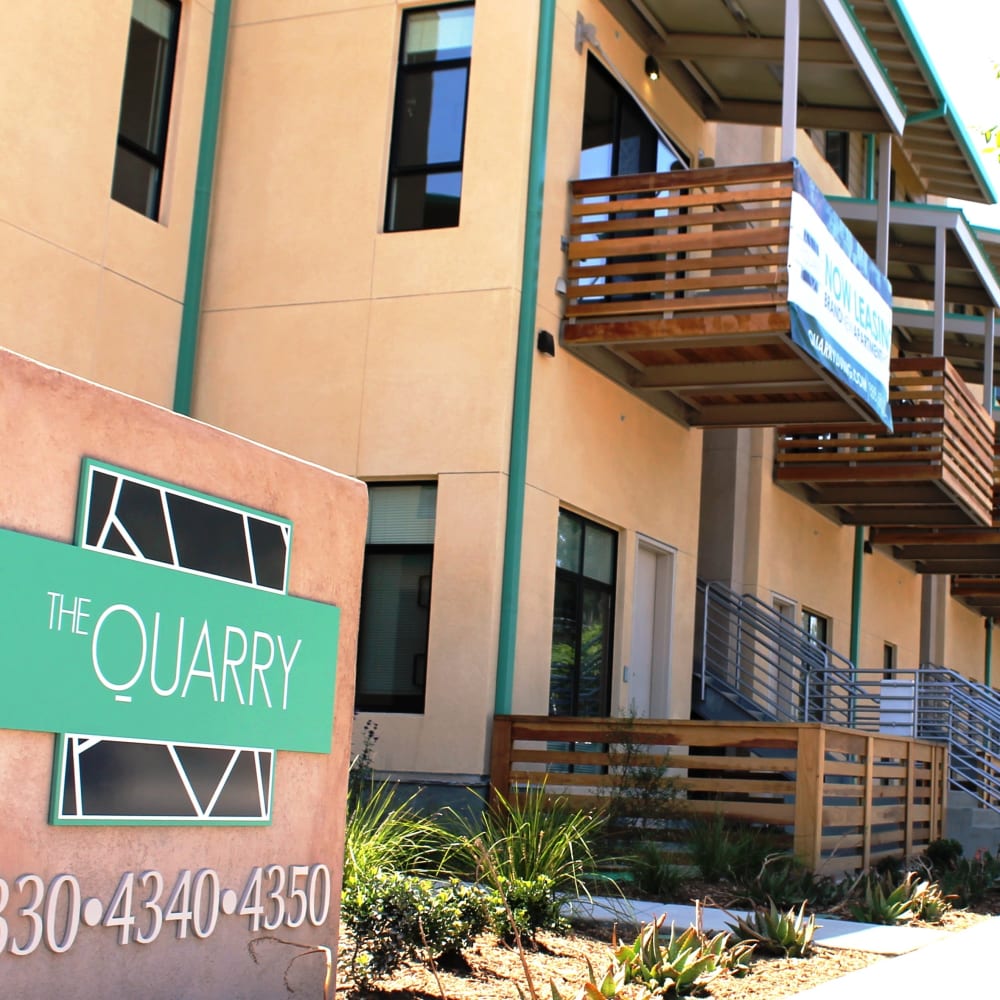 Exterior building and sign at The Quarry Apartments in La Mesa, California