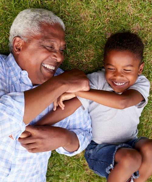 Grandfather and grandson playing in the park near Briar Cove Terrace Apartments in Ann Arbor, Michigan