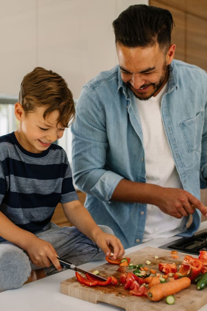 Father and song cooking together at Lake Merritt Apartments in Oakland, California