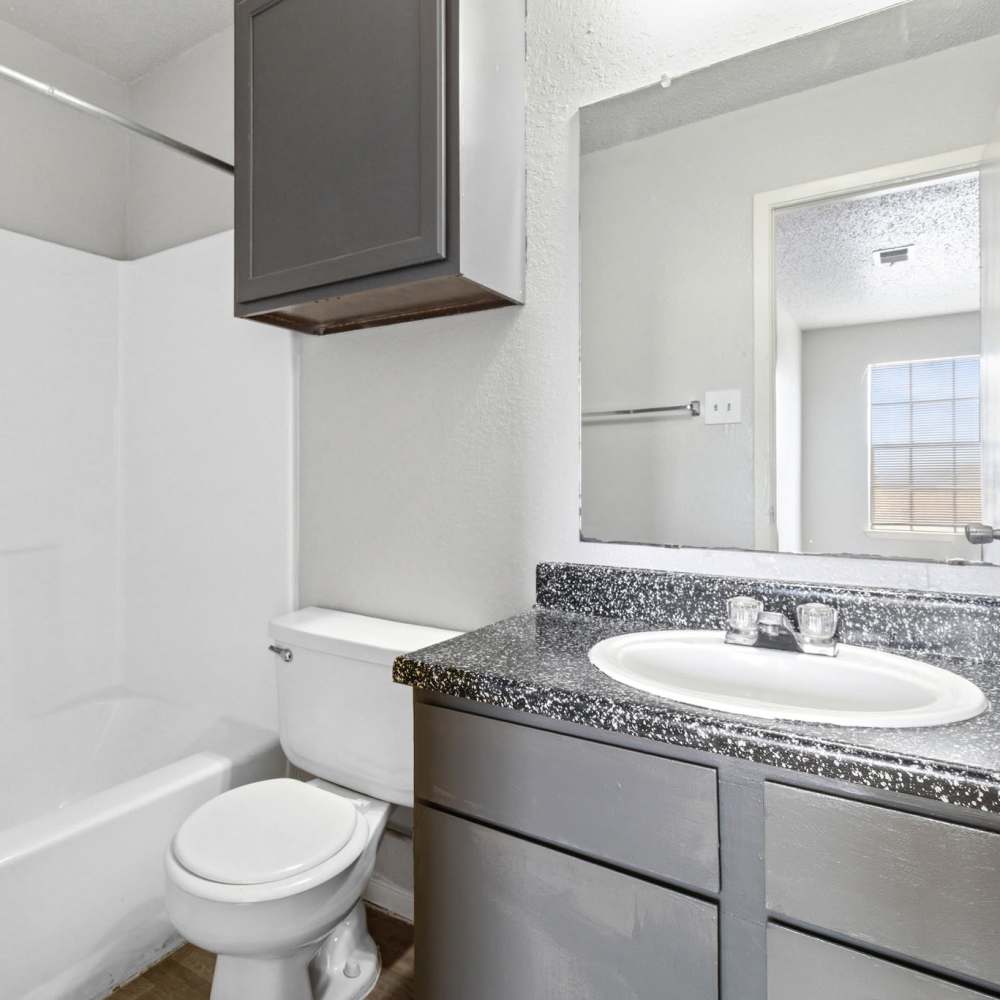 Bathroom with vanity storage and bathtub at Arbors of Taylor in Taylor. TX