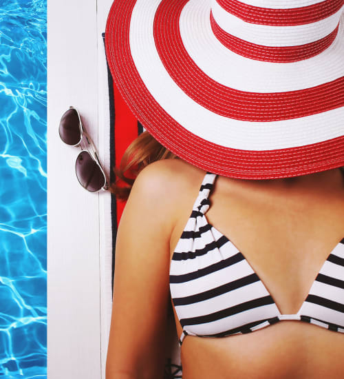 Resident relaxing by the pool at Lakeshore Pearl in Austin, Texas