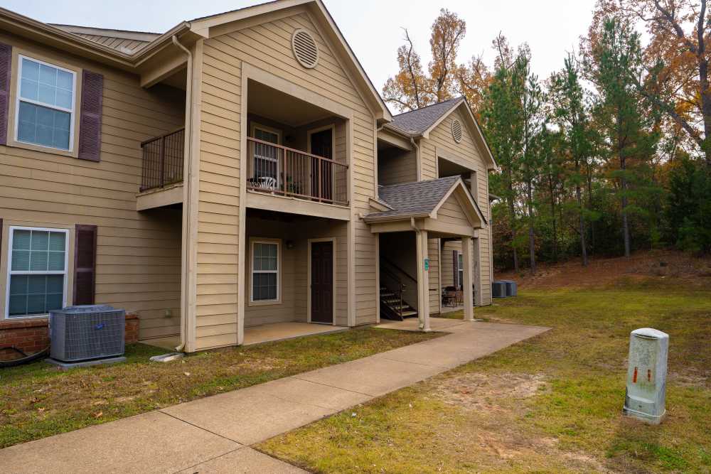 Exterior view of the community with pathway at Jacksonville Pines in Jacksonville, Texas