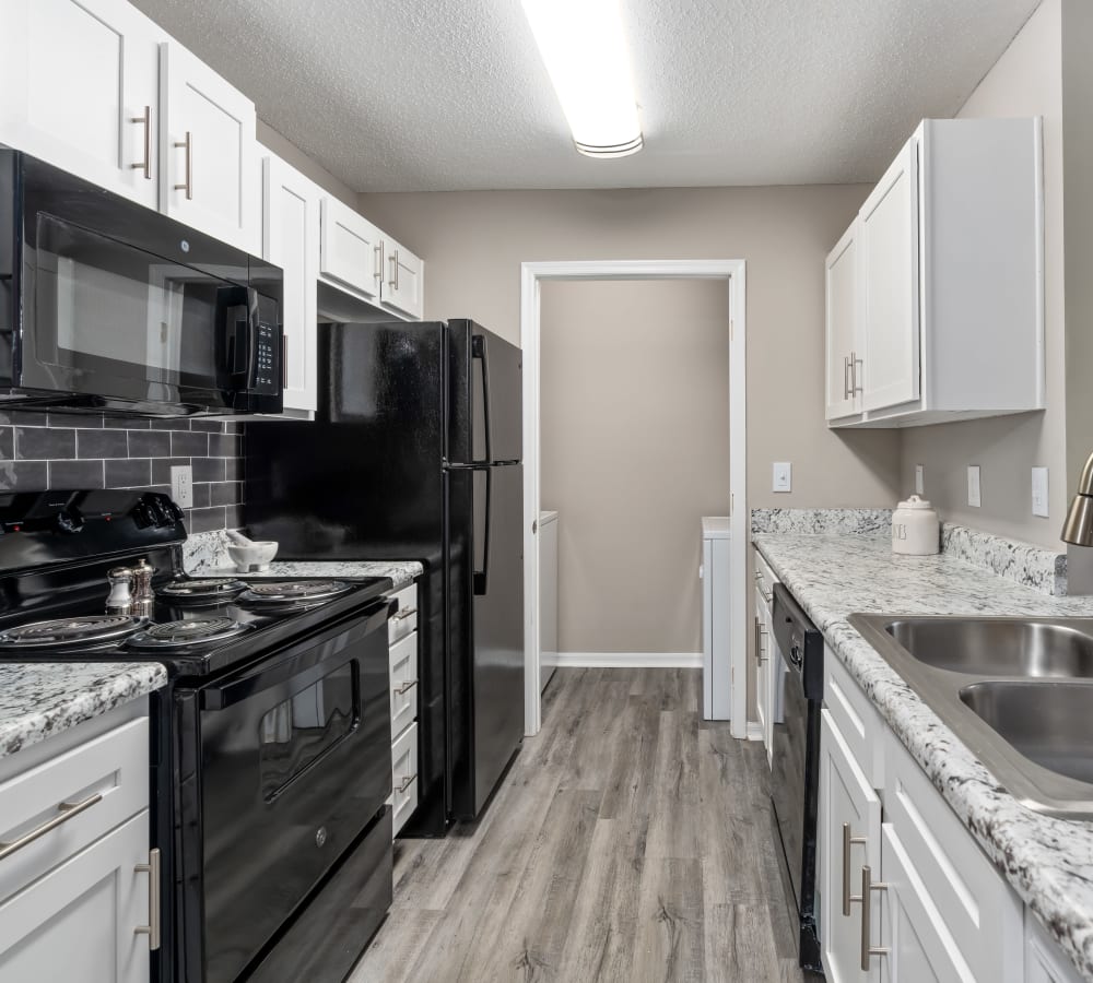 Black appliances in a model apartment kitchen at Arbor Gates in Fairhope, Alabama