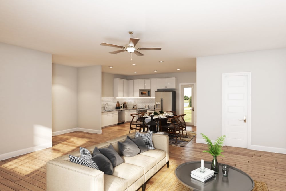 Rendering of the living room area with wood style flooring and a ceiling fan at The Guild in Chattanooga, Tennessee