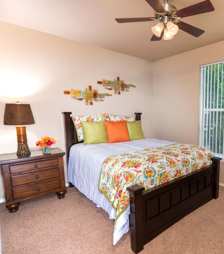 Model bedroom with a ceiling fan at Lakeview at Parkside