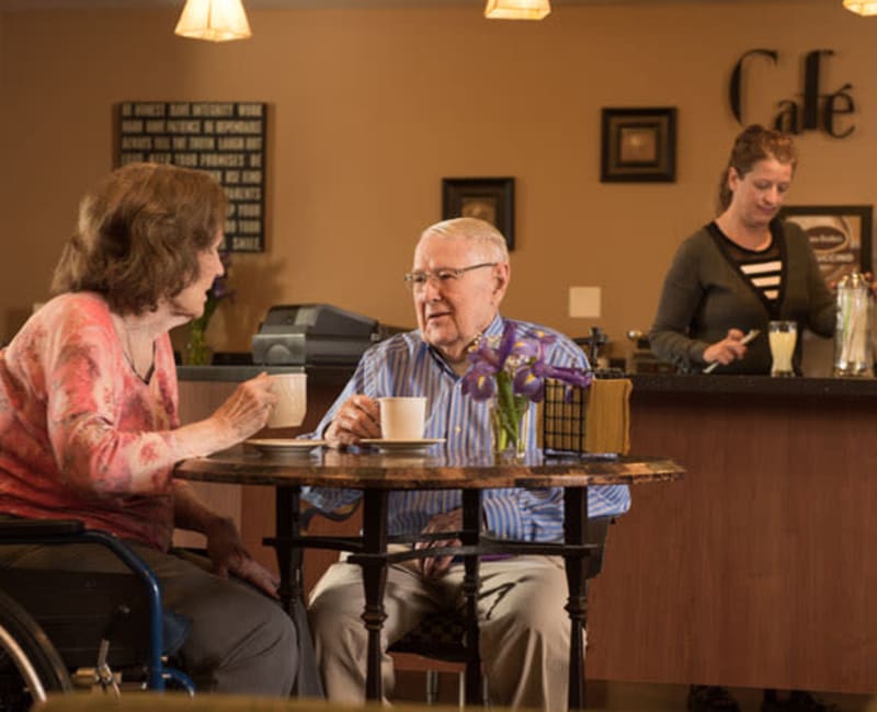 Two residents sitting in the cafe and talking at York Gardens in Edina, Minnesota