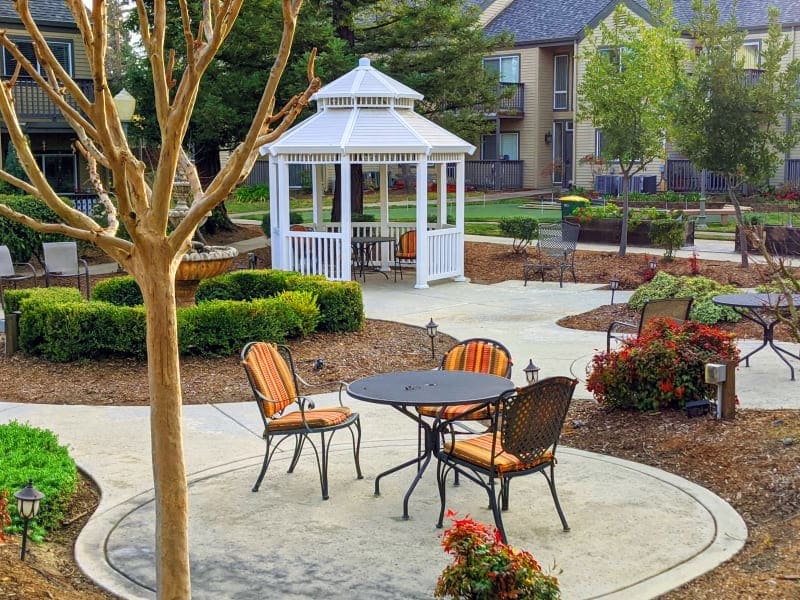 Cheerful courtyard seating at Blossom Vale Senior Living in Orangevale, California.