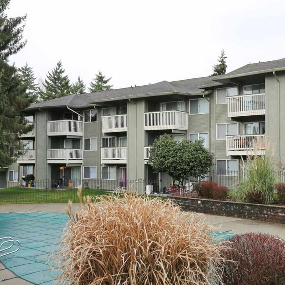 Swimming pool and building exterior at Bluffs at Evergreen in Everett, Washington