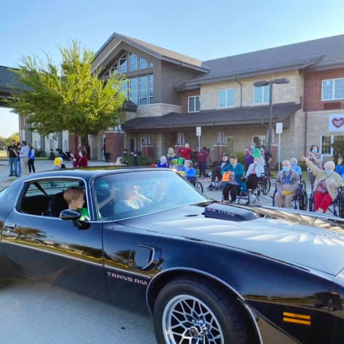 Resident riding in a muscle car outside of The Oxford Grand Assisted Living & Memory Care in McKinney, Texas