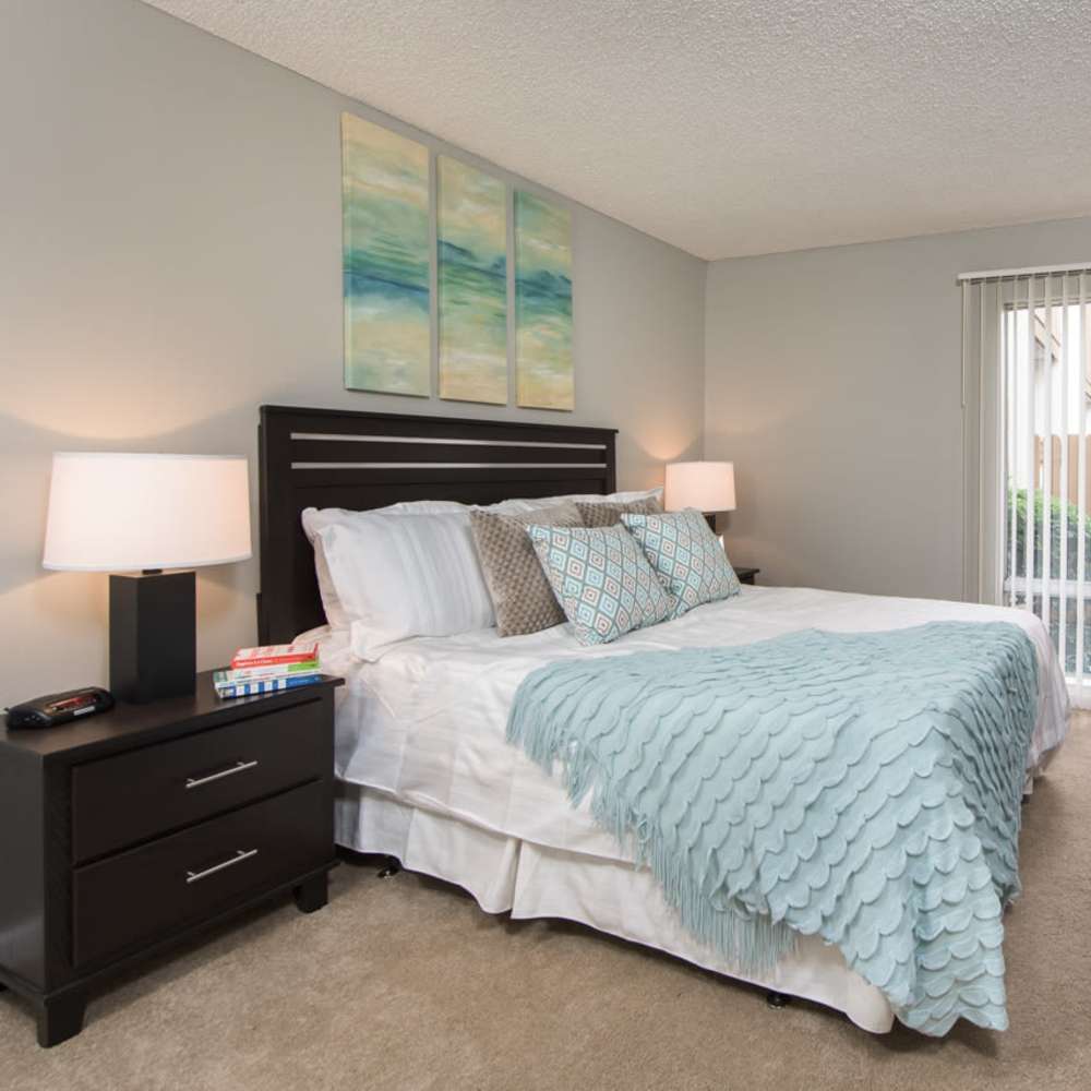 Bedroom with large bed and a window at Lawrence Road Apartments in Santa Clara, California