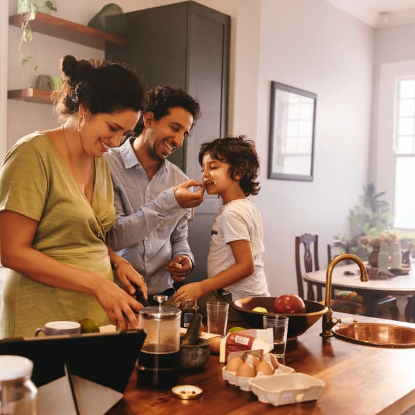A family with prepares a meal in their kitchen at Attain at Towne Place, Chesapeake, Virginia