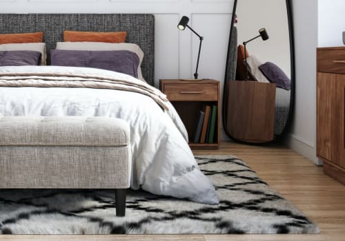 Bed with rug and hardwood floors at Brookside Commons in East Hartford, Connecticut