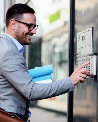 Resident keying his code into the secure electronic entrance at 700 Broadway Seattle, Washington