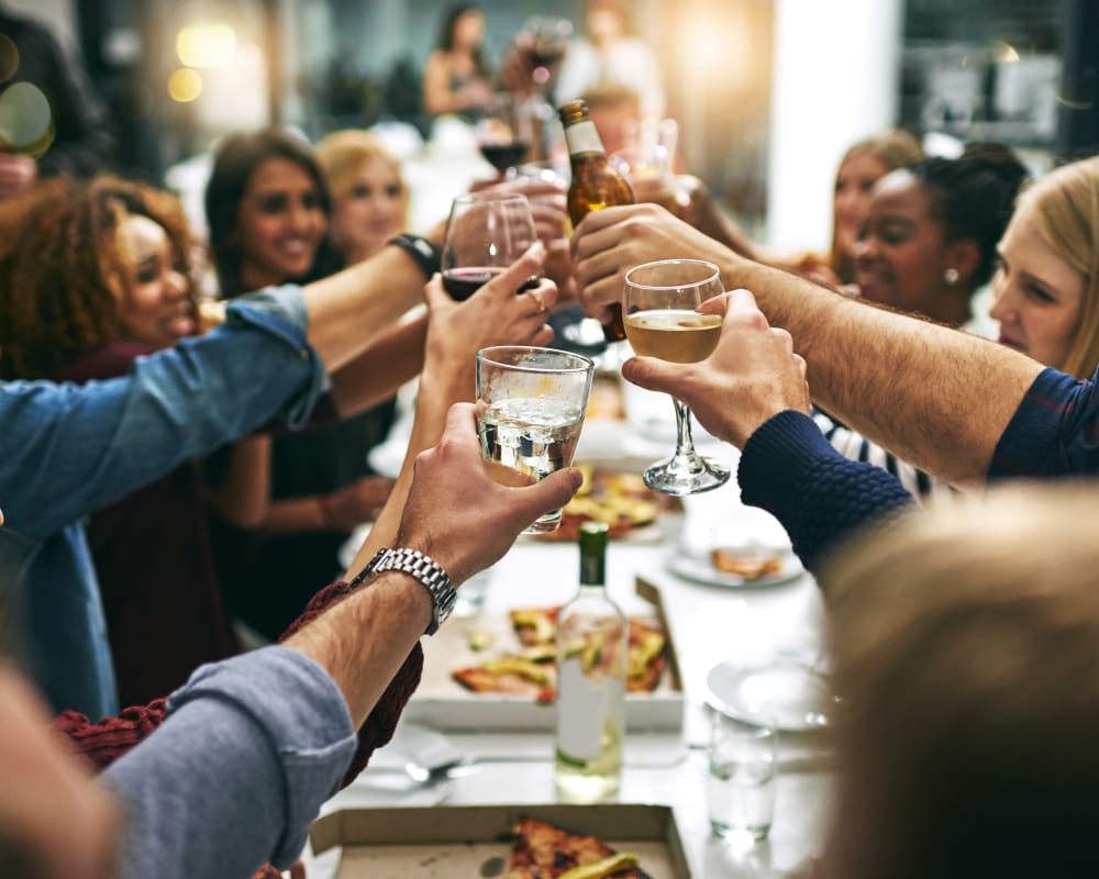 Group of resident friends out for a meal at their favorite restaurant and raising a toast to the good life at Domus on the Boulevard in Mountain View, California