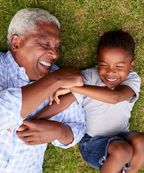 Grandfather and grandson playing in the park near Lakeside Terraces in Sterling Heights, Michigan