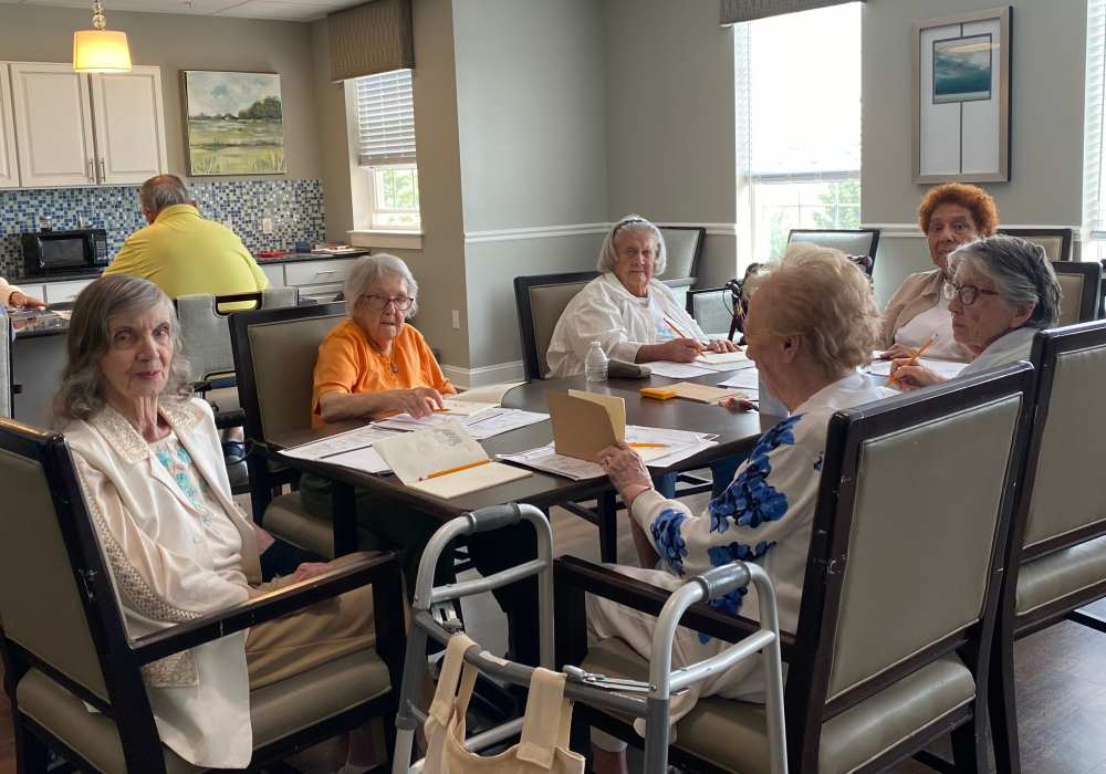 Residents gathering around a table in Merrill Gardens at West Chester in West Chester, Pennsylvania