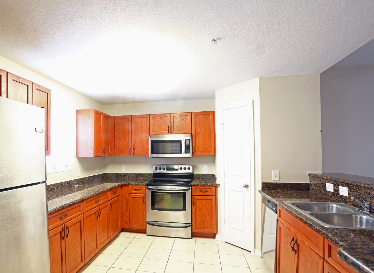 A large kitchen with stainless-steel appliances at Town Park Villas in Tampa, Florida