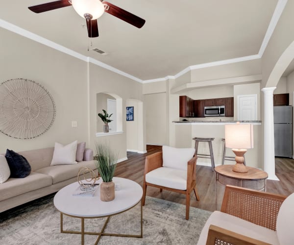 The luxurious living room with view of kitchen at The Estates of Northwoods