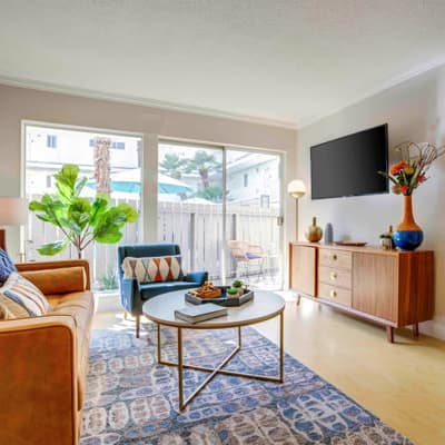 Open-concept layout with built-in shelving in the living area of a model home at Sofi Redwood Park in Redwood City, California