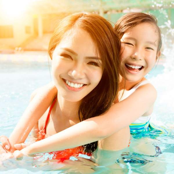 Woman relaxing at the poolside at The Abbey at Eagles Landing in Stockbridge, Georgia