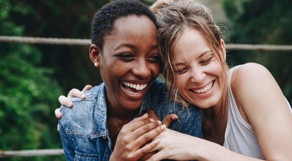 Residents laughing together near Summer Creek Apartments in Houston, Texas