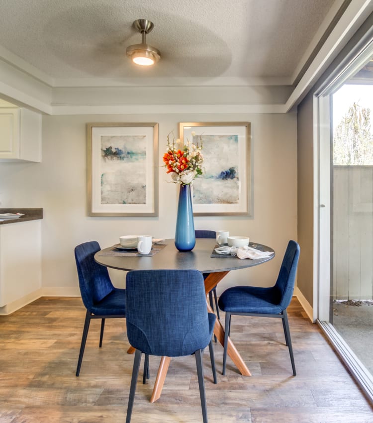 Dining area with a ceiling fan next to a model home's private patio at Sofi Fremont in Fremont, California